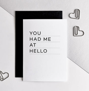 White greetings card with bold black text 'You Had Me At Hello' and black envelope.